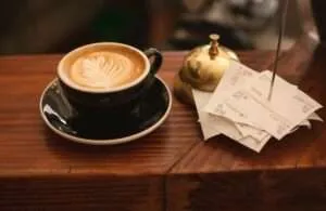 Coffee cup and receipts in a cafe.