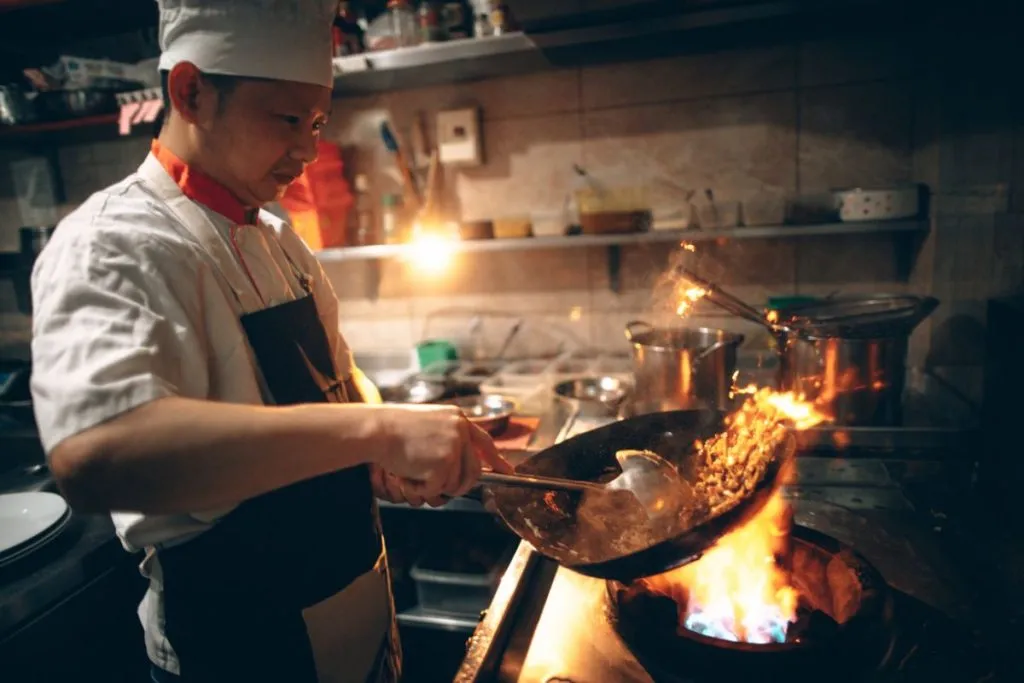 Star Micronics Solutions for All Industries 3 A chef cooks in an Asian restaurant.